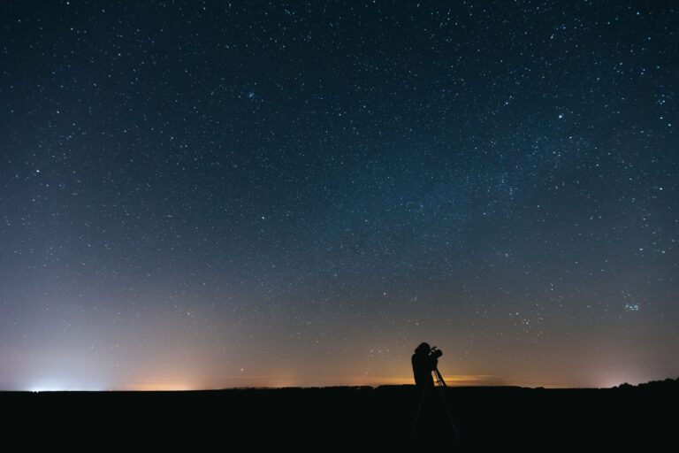 Telescope on a tripod at sunset, setting up to see Jupiter and its moons
