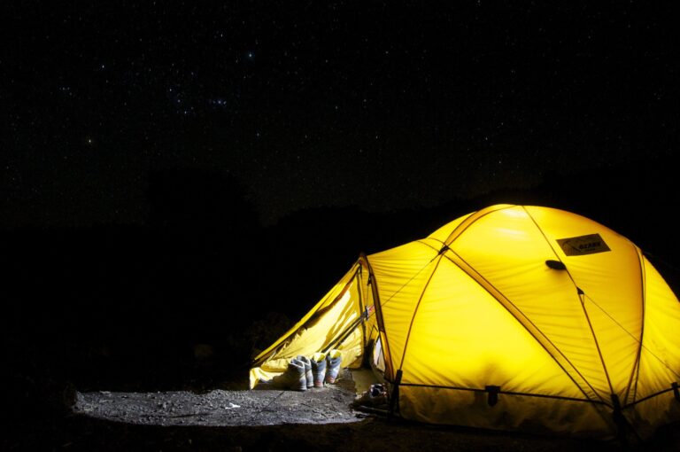 Camping under the stars at night, using a red headlamp for astronomy
